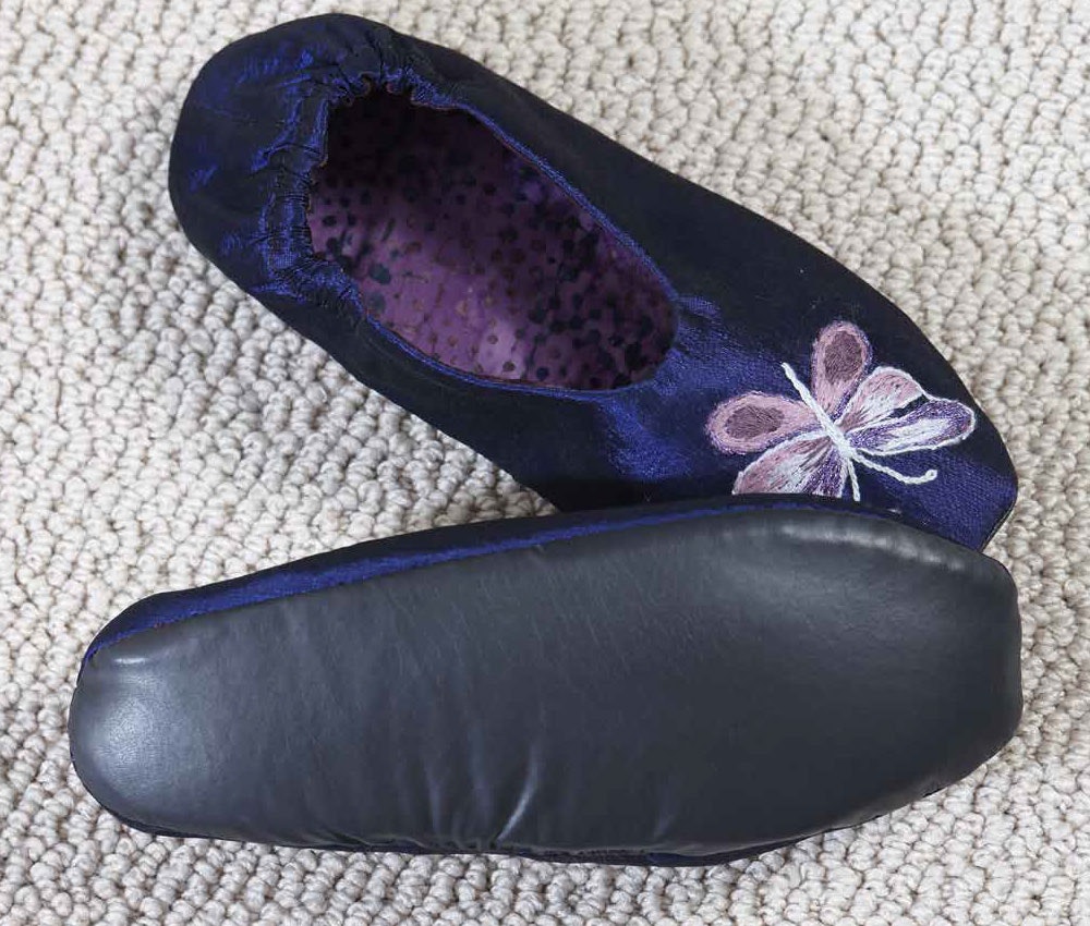 The Naugahyde sole on the slippers will keep your feet dry in most airplane situations.