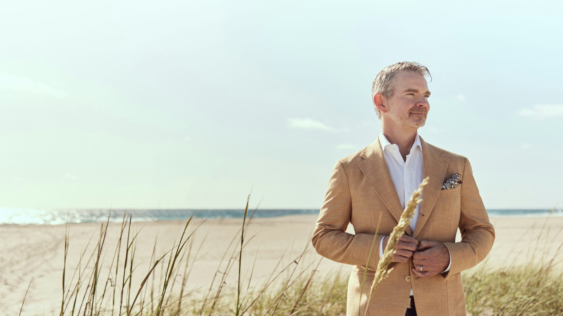 Dr. Mark R. Murphy in a suit by the beach