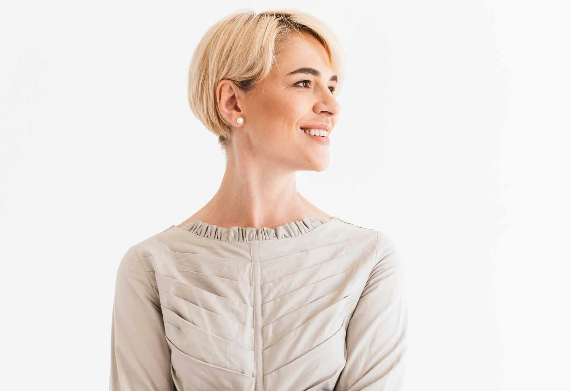 Woman with short blond hair looking to the side