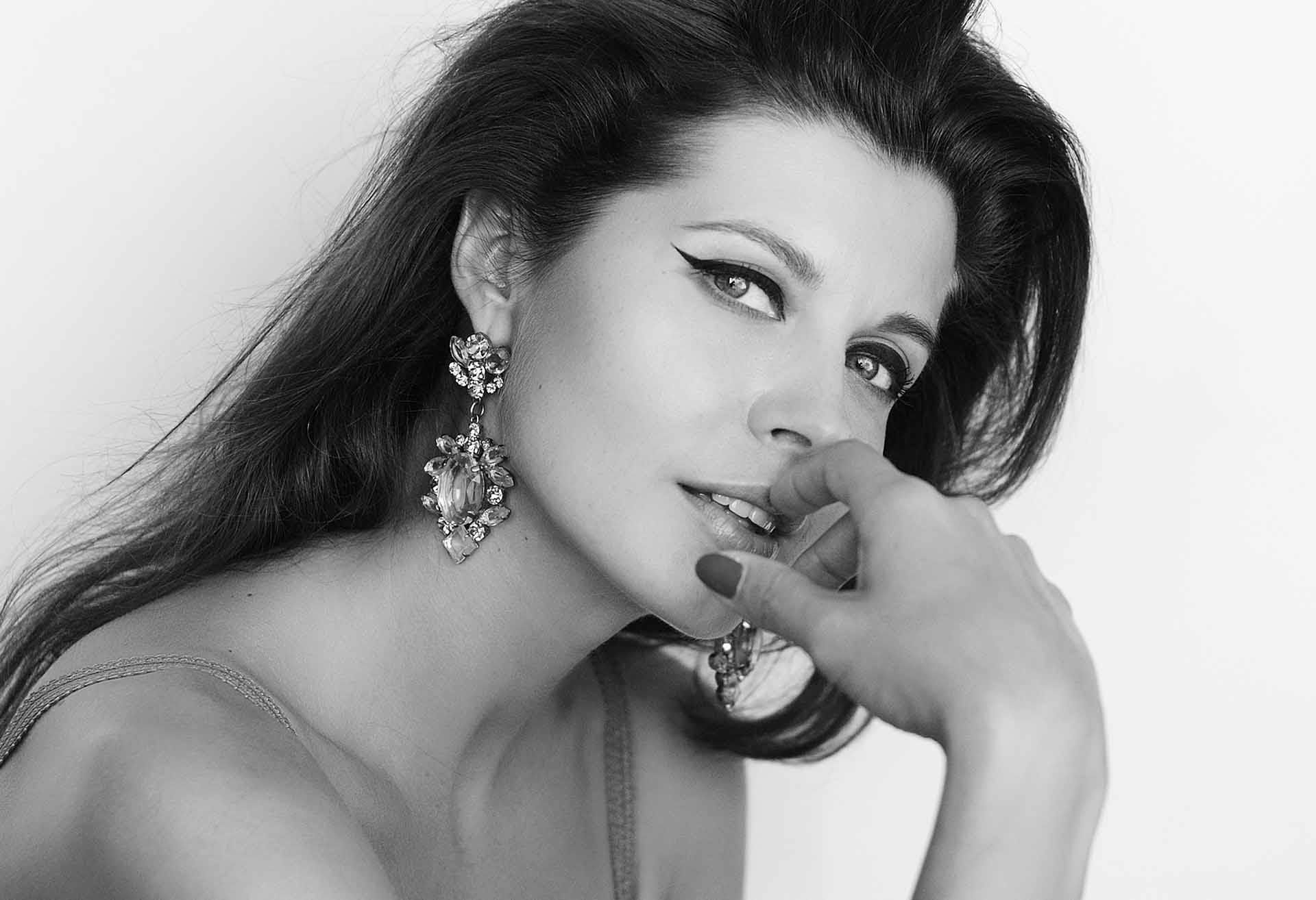 Black and white photo of a woman with a finger to her lips