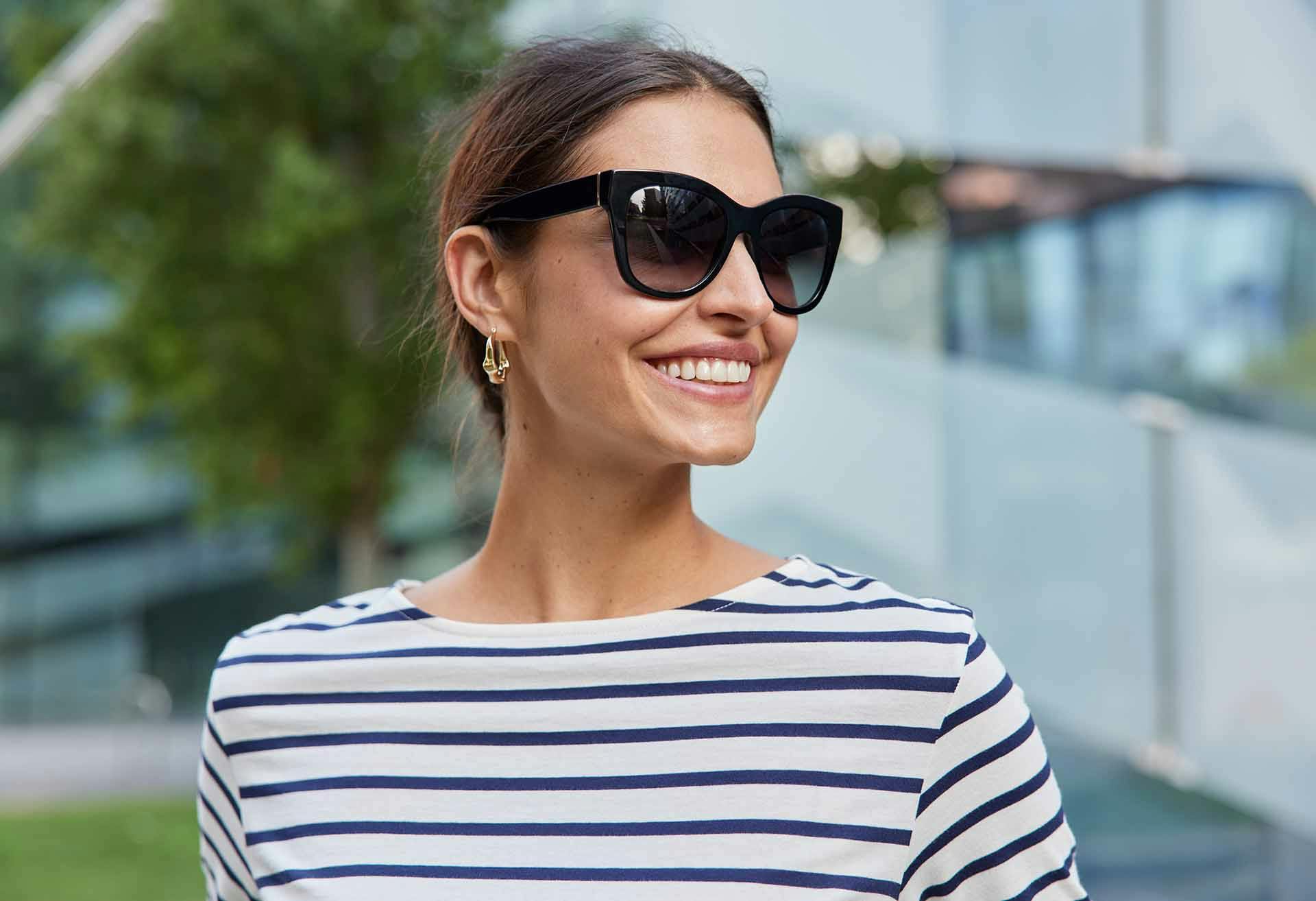 Woman in shades smiling