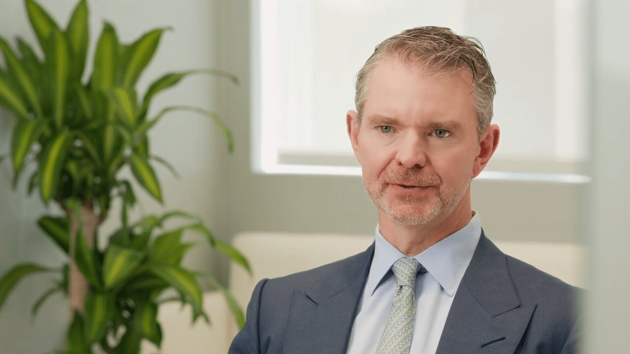 Dr. Mark Murphy in a suit, sitting down