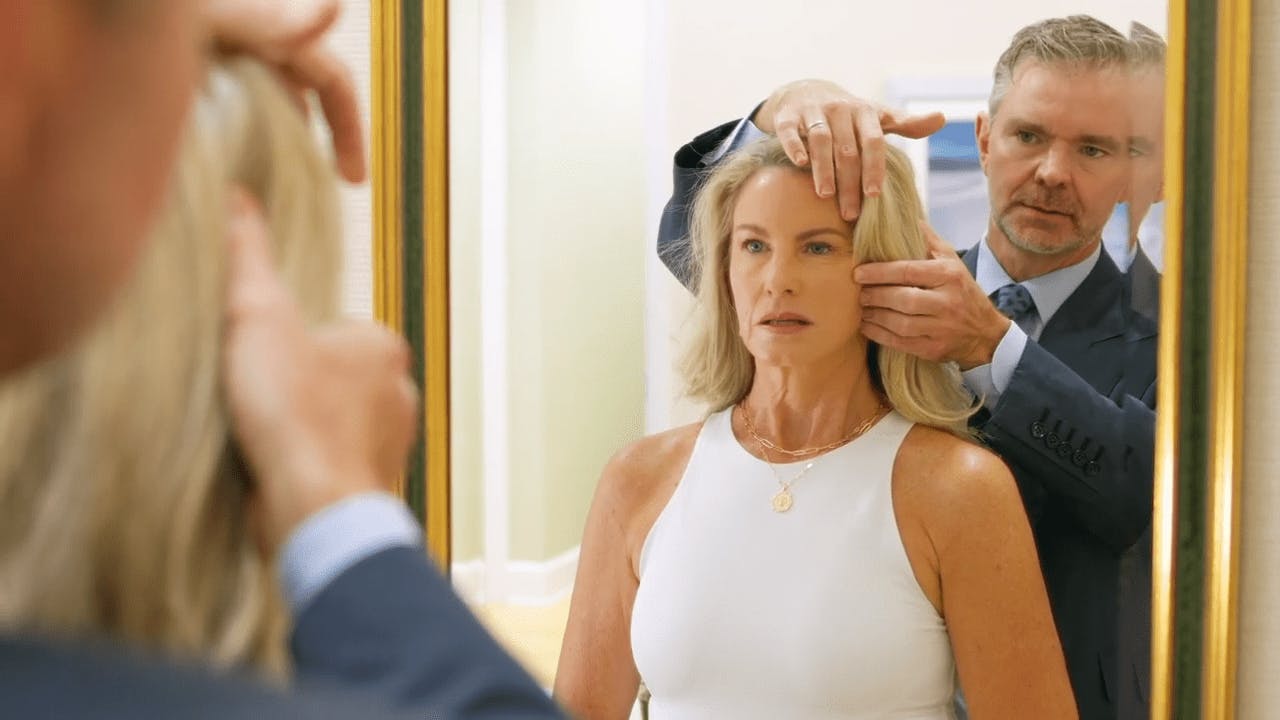 Dr. Mark Murphy helping a patient looking in the mirror