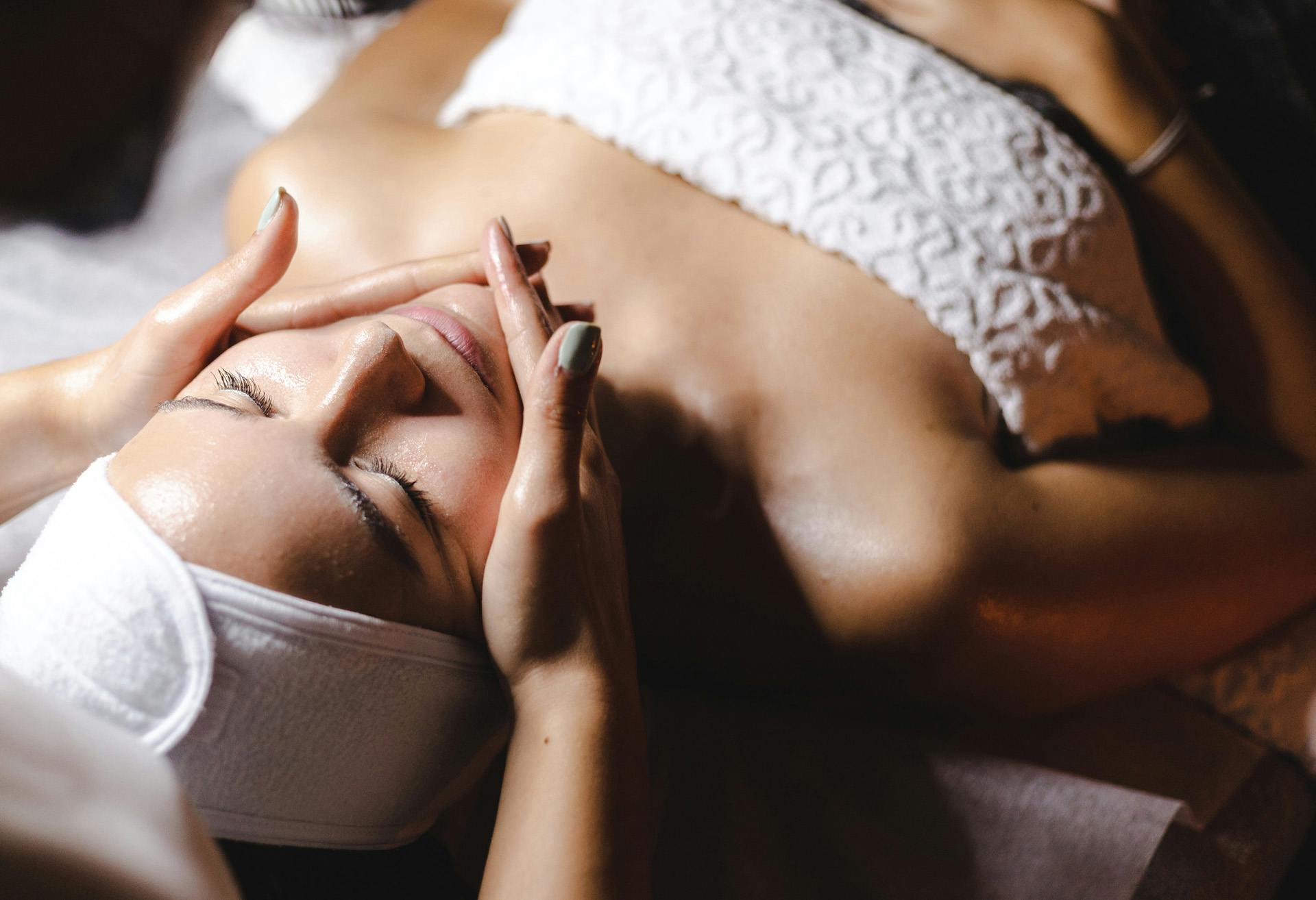 Woman lying down, getting a facial