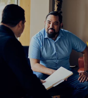 Photo of two men working together
