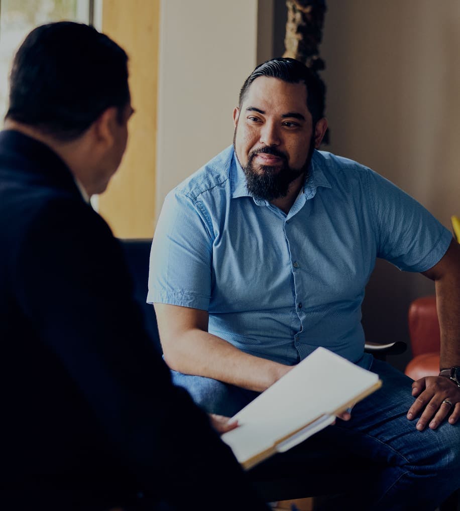 Photo of two men working together
