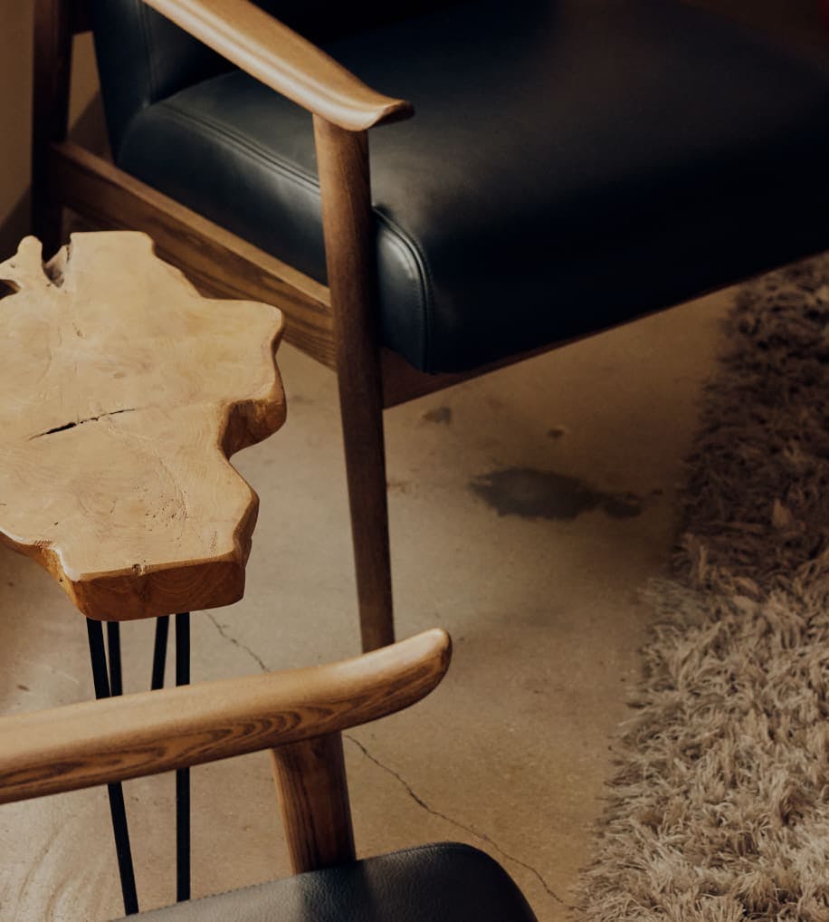 Image of two chairs and a side table
