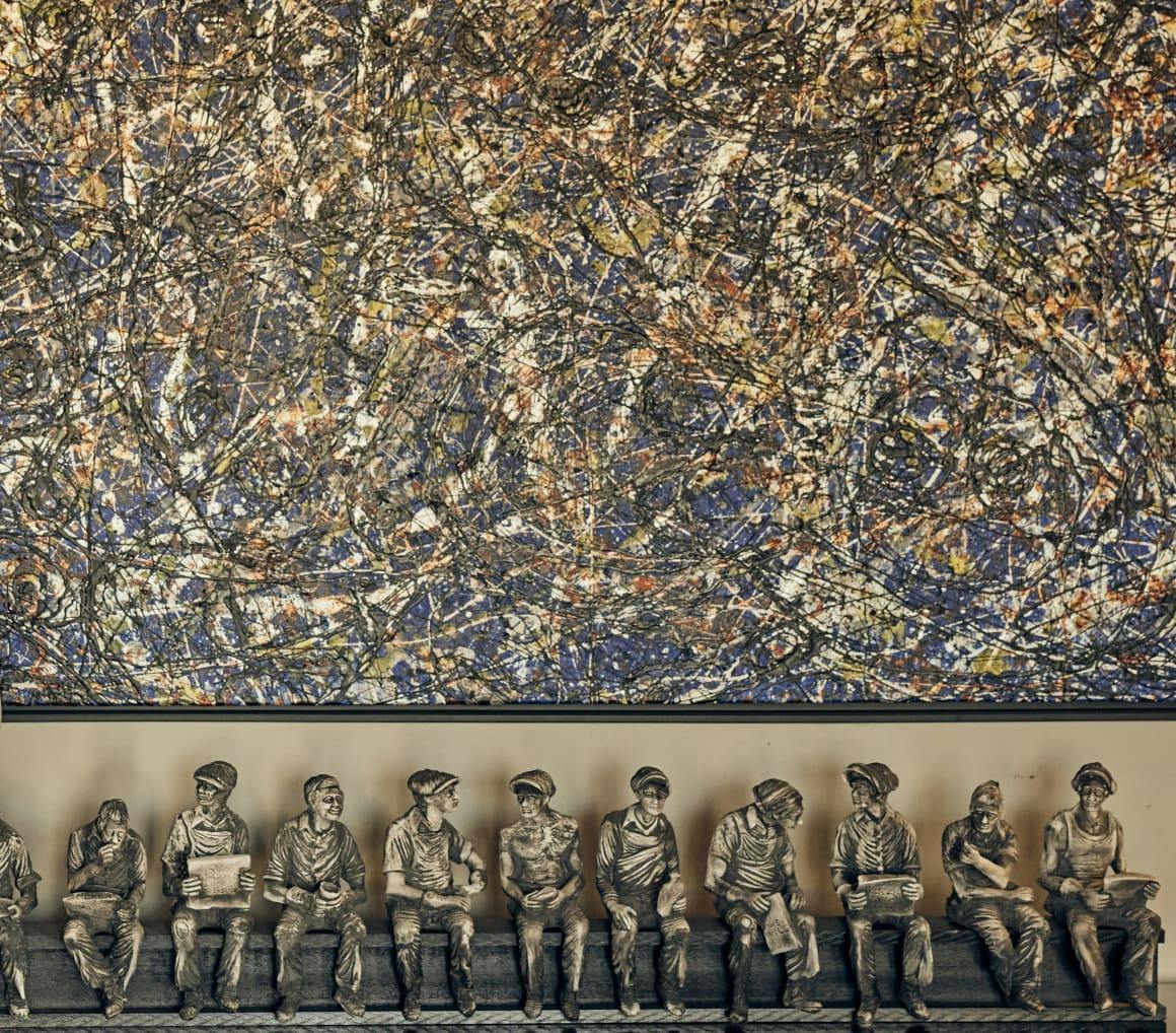 Statue of workers on a bench.