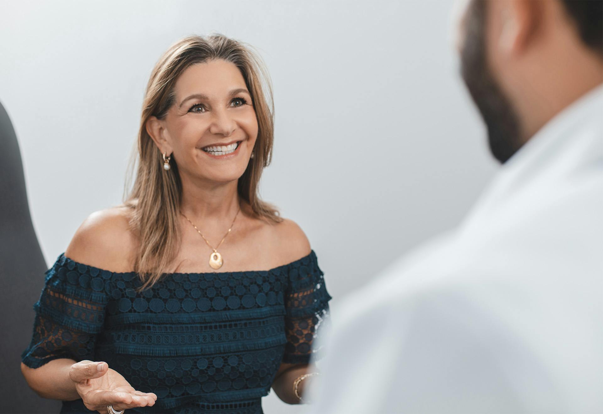Female Patient Smiling and Speaking with the Doctor