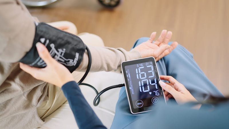 Nurse checking blood pressure
