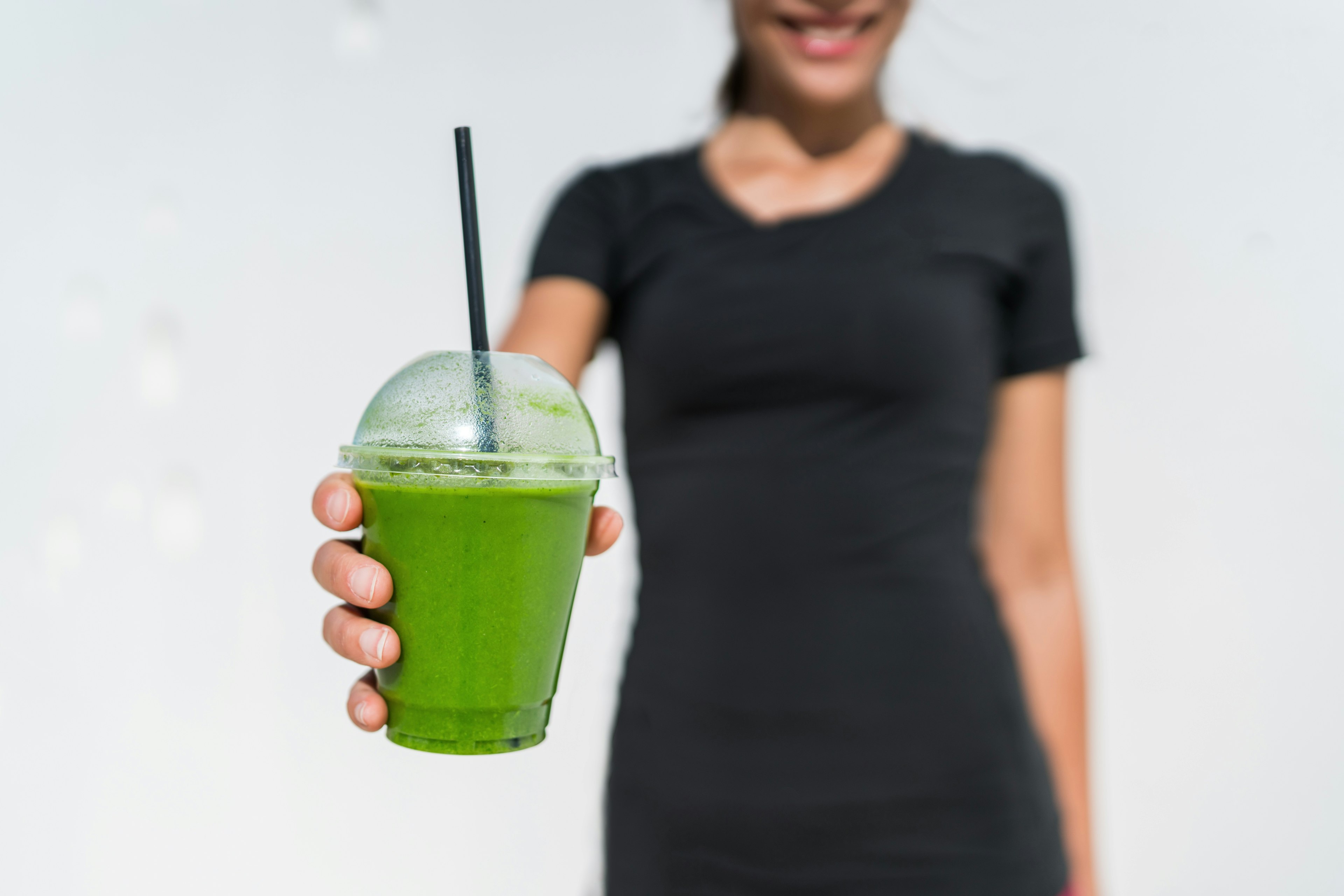 Happy woman holding healthy drink
