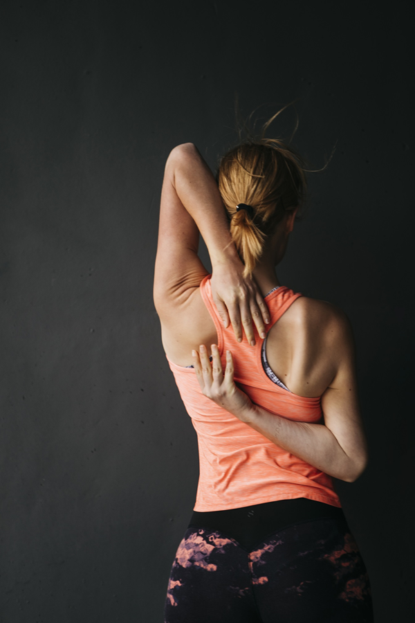 sporty-woman-stretching-urban-environment
