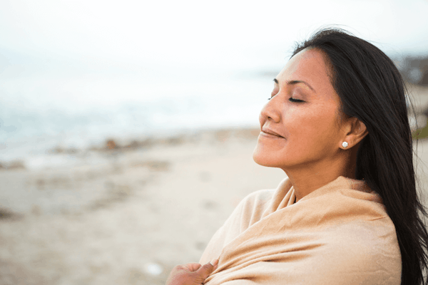 Lady smiling near beach