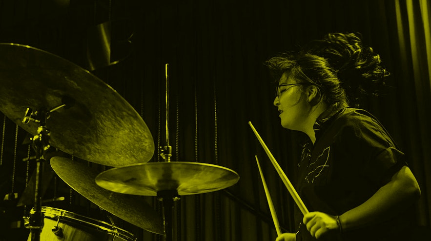 Person energetically playing the drums