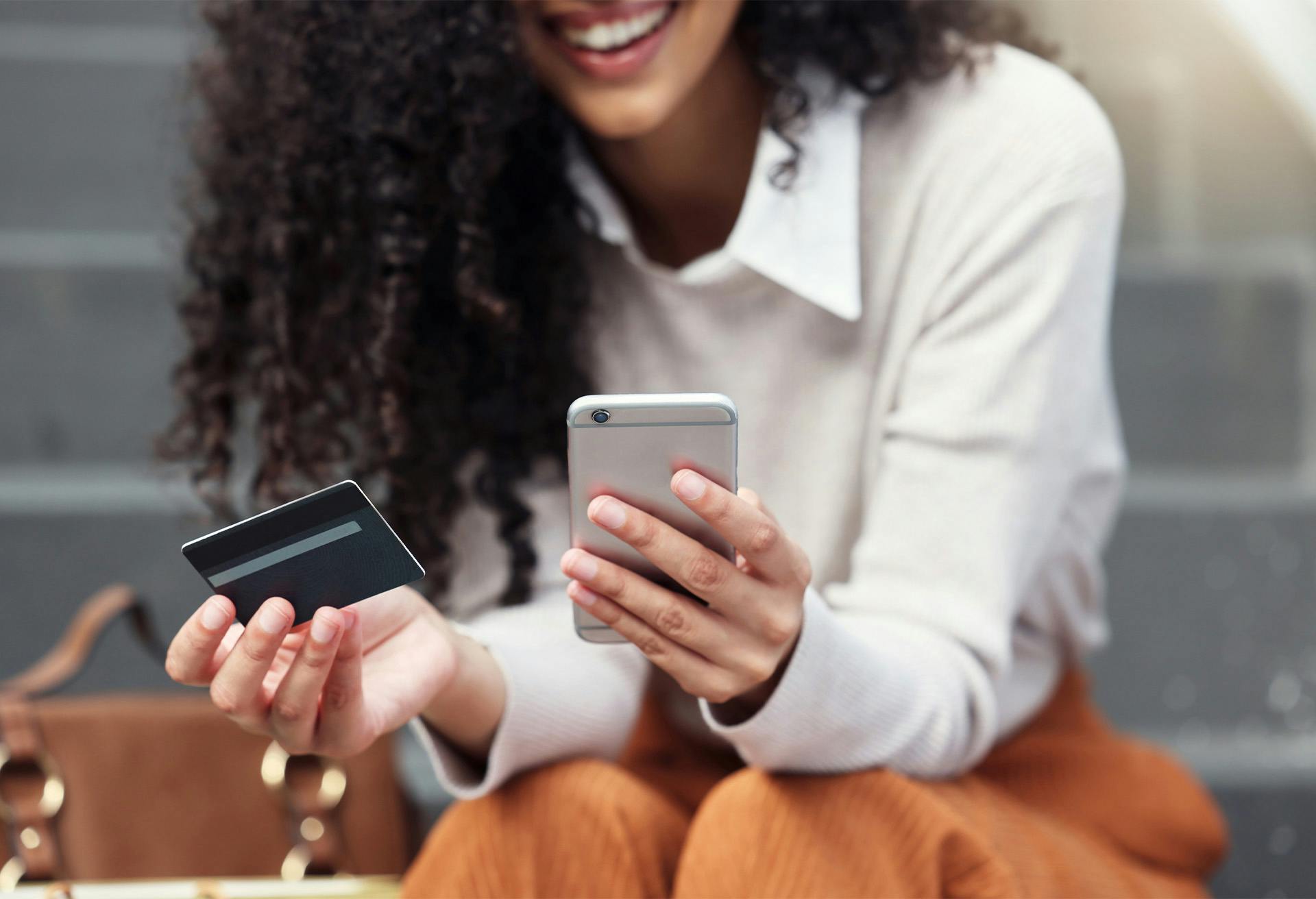 Woman holding a phone and card