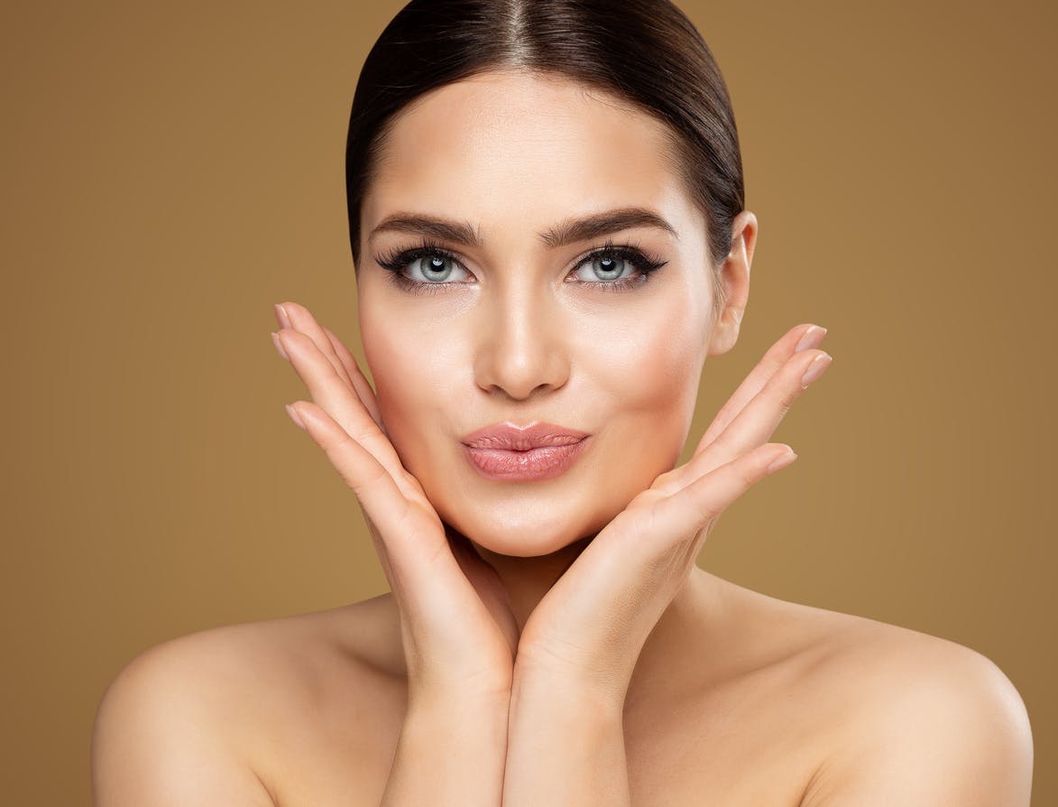 Woman holding hands under chin