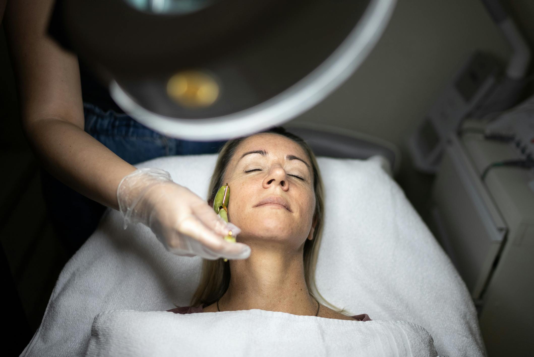 Woman receiving facial treatment
