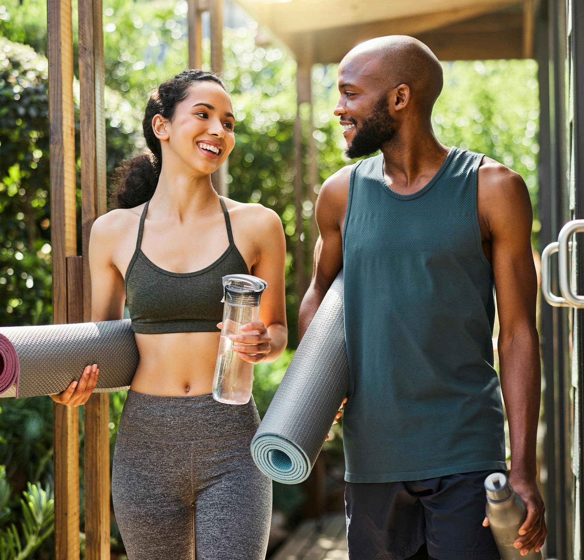 Man and woman in yoga outfits talking