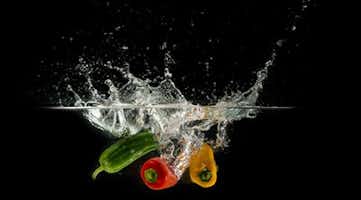 Produce dropping into clear water and making a splash.