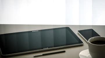 tablet, cell phone and cup of coffee
