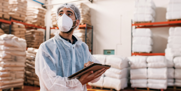 man using tablet in warehouse