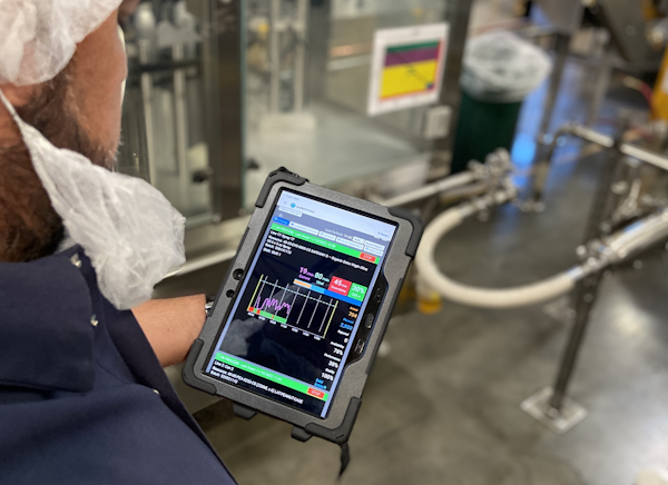 Operator holding a tablet with real-time plant management data