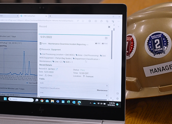 Laptop open to a maintenance downtime report in SafetyChain