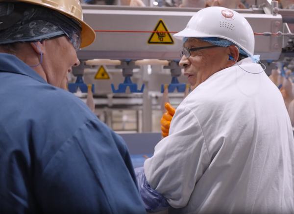 An operator and supervisor talking on the plant floor