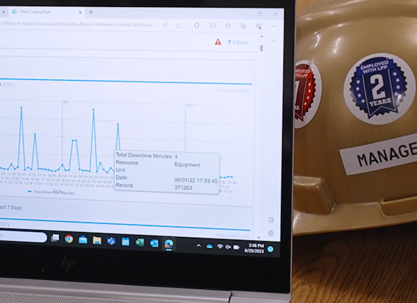 Laptop open to a downtime report in SafetyChain