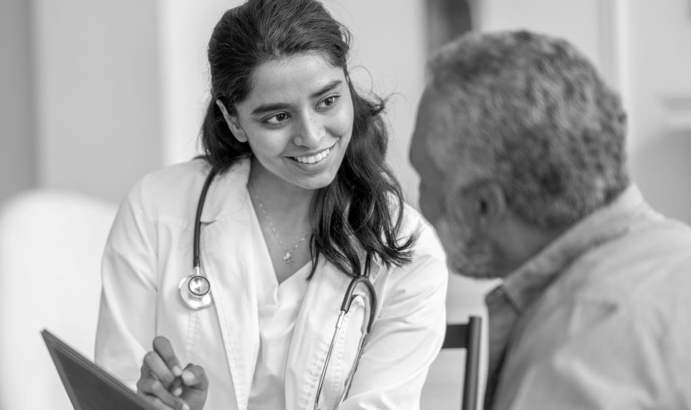 Doctor smiling and helping patient
