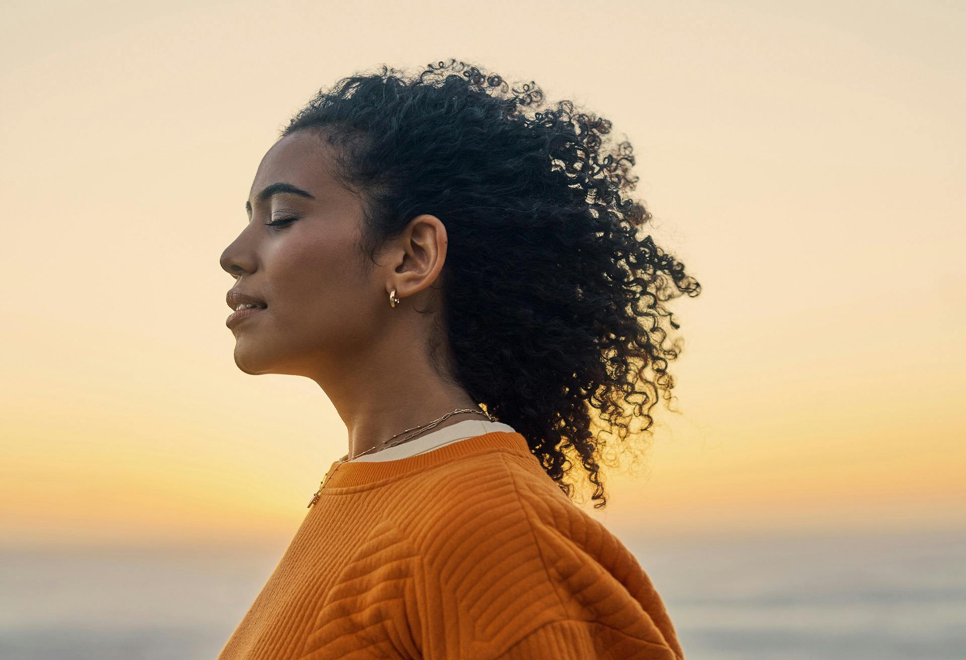Woman in an orange sweater