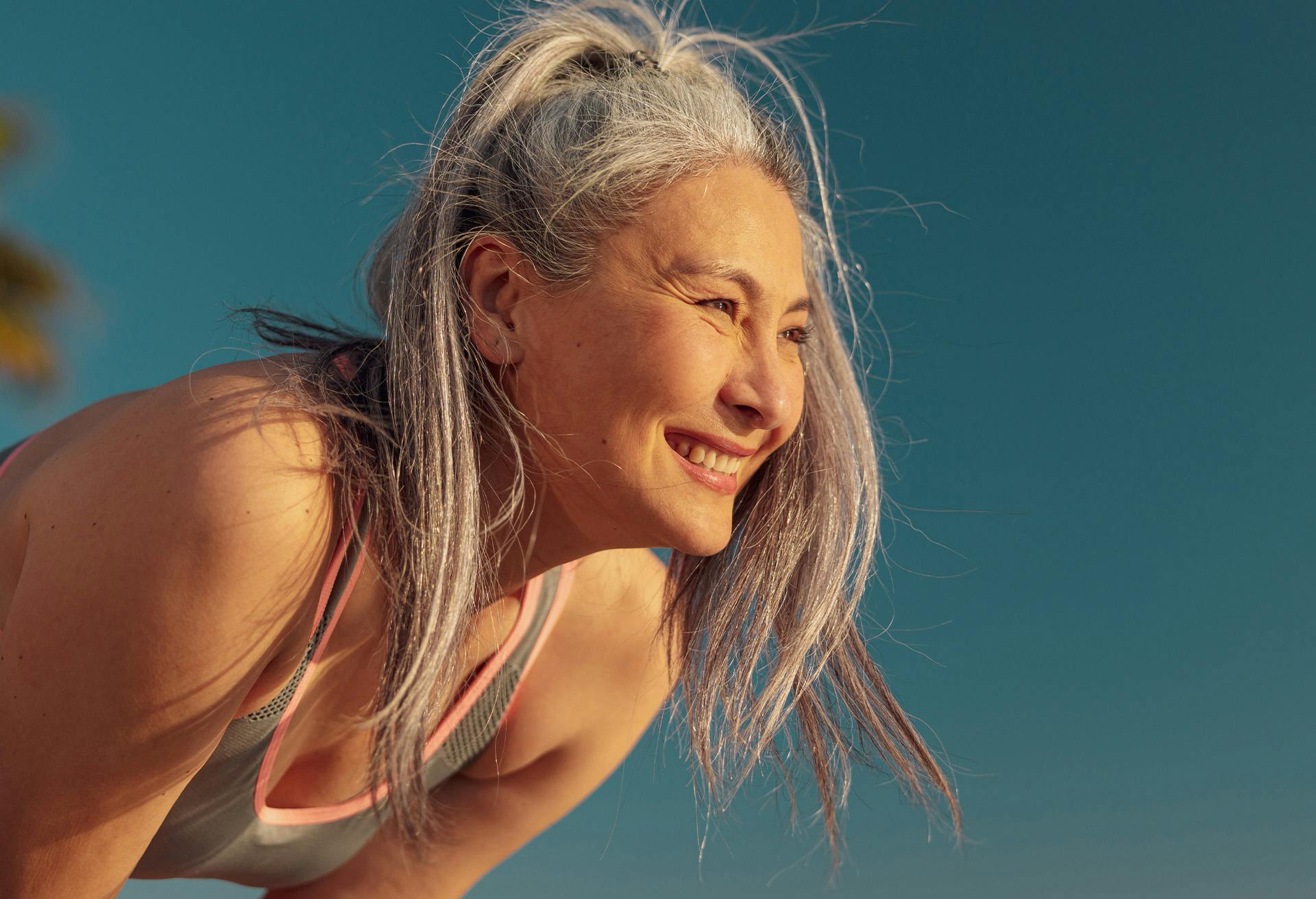 Older woman with her grey hair in a ponytail