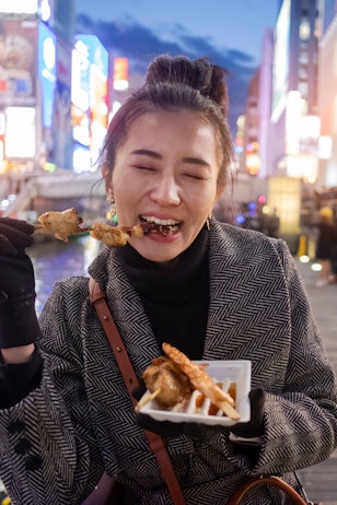 Woman Eating Kushikatsu