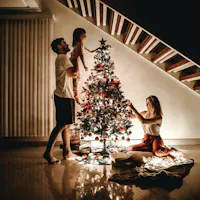 Christmas at home in Japan, where the cake comes out on the evening of the 24th A family decorating a lit Christmas tree at home in Japan