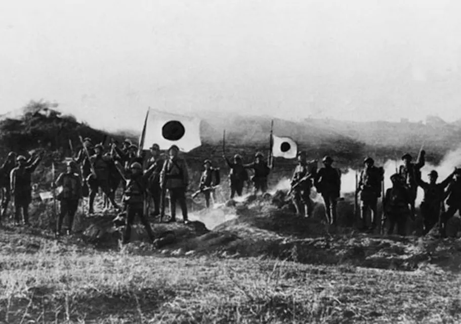 Historical photograph illustrating Japan's militarism during WW2, showing soldiers in formation with Japanese flags in the background.
