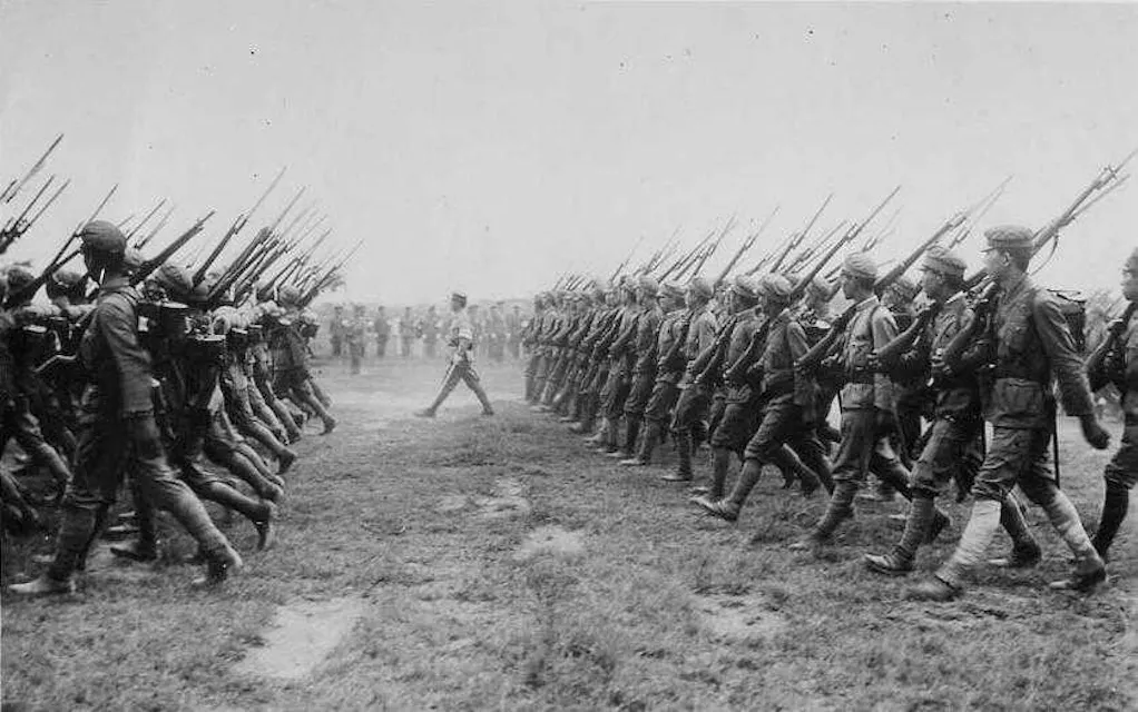 Soldiers of the Japanese Imperial Army marching in symmetry portrayed in a historical black and white image