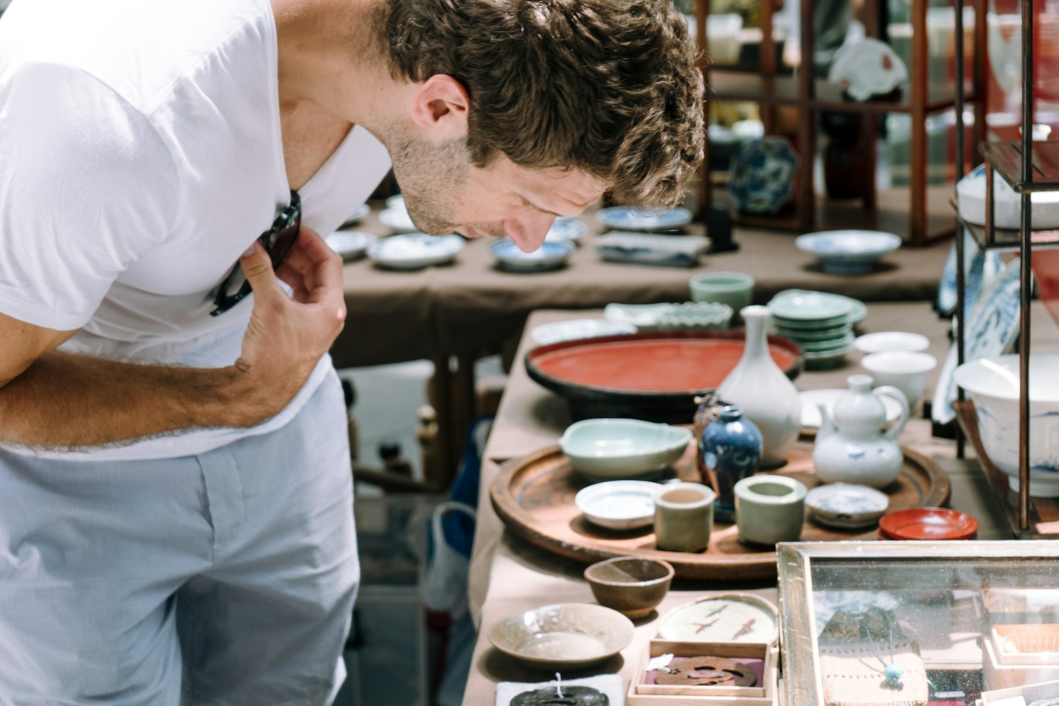 A male customer is looking at the goods at Oedo Antique Market