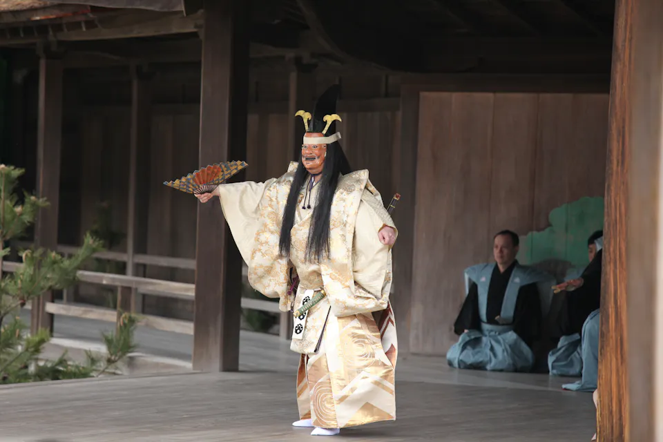 Noh artist is performing on the Itsukushima shrine stage