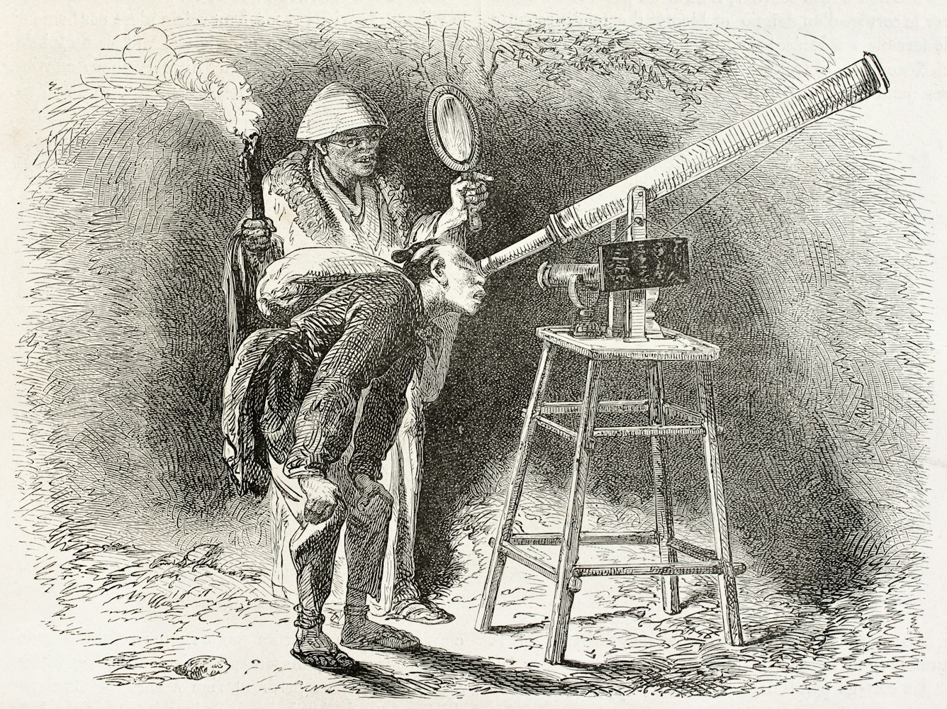 Japanese astronomer looking into telescope