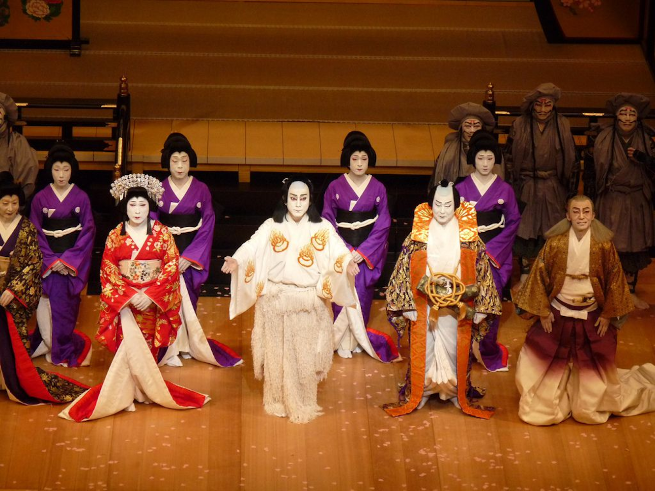 A captivating ensemble of theater artists, adorned in exquisite traditional Japanese attire, captivatingly performing a mesmerizing show.