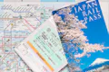 Two Japan rail pass (JR Pass) over a Tokyo subway map