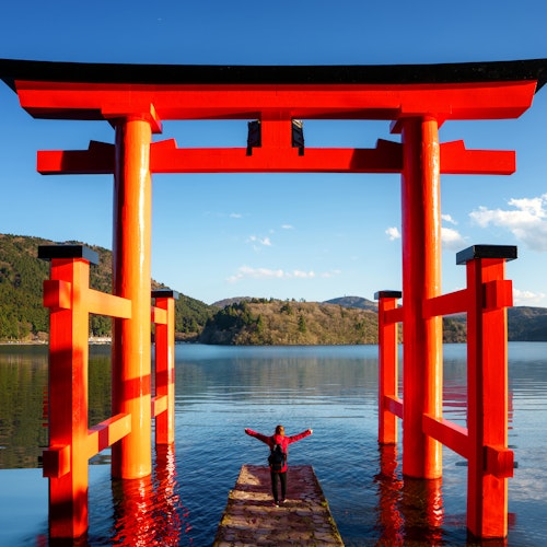 Traveller Stand on Red Torii on the Hakone Lake