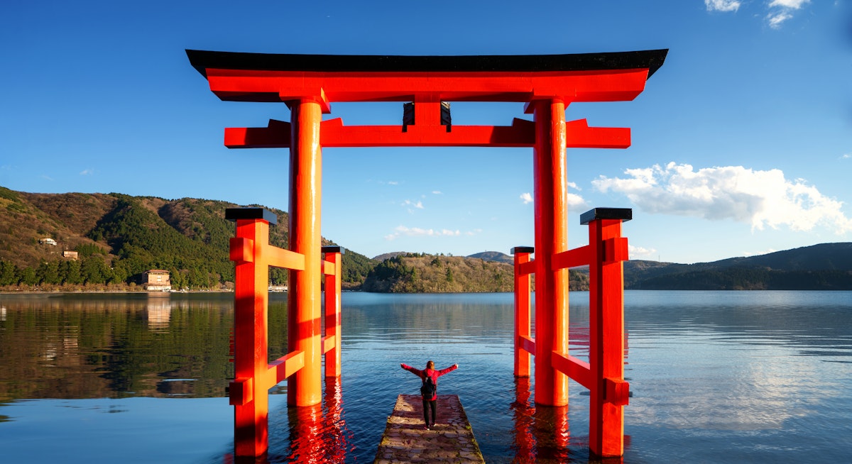 Traveller Stand on Red Torii on the Hakone Lake