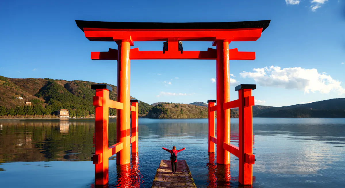 Traveller Stand on Red Torii on the Hakone Lake