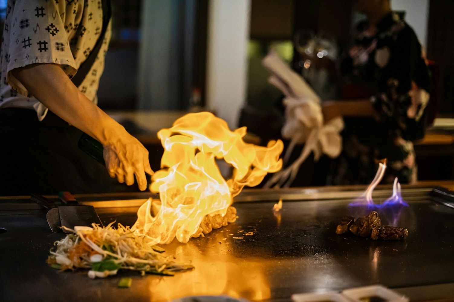 Tepanyaki - japanese grilled beef on pan. chef cooking at the hot table