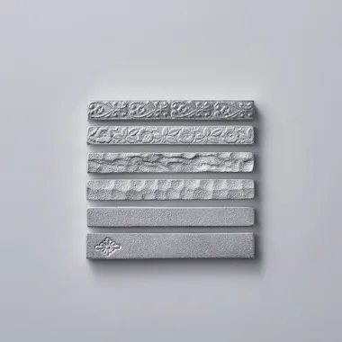 Engraving Workshop Seven silver metallic bars with different embossed patterns and textures are arranged horizontally in a neat vertical stack on a plain white background.