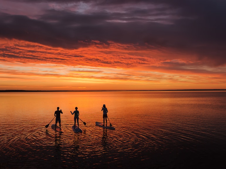 宮古島の夕暮れ、真紅の夕日に包まれて。サンセットSUPまたはカヌーツアーをお選びください