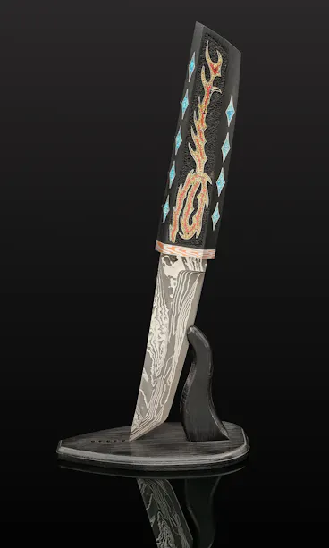 Hand-Forged Japanese Samurai Knife A decorative knife with an intricately patterned blade and a handle featuring colorful, artistic inlays, displayed upright in a black, curved stand against a dark background.