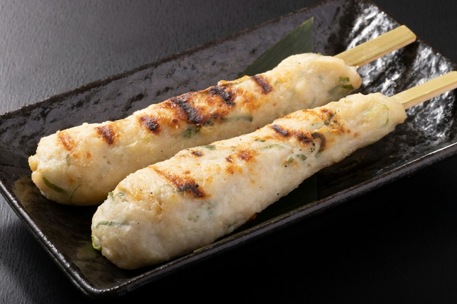 Tsukune skewers with Kujo green onions and Nagoya Cochin, with Nagoya Cochin