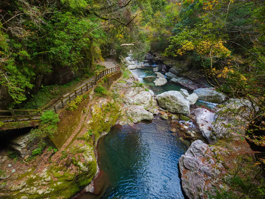 Beautiful landscape of clear blue water and red maple leaves in autumn Beautiful landscape of clear blue water and red maple leaves in autumn